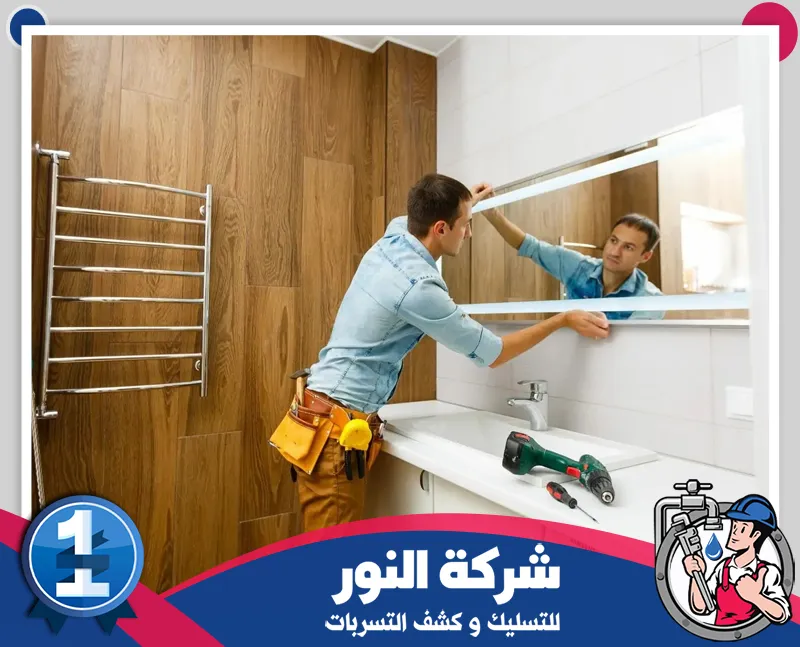 تكسير حمامات بالقطيف 0546824999 النور للتسليك فني يقوم بتركيب وتجهيز مرآة الحمام ضمن أعمال التشطيب النهائية بعد تنفيذ الترميم والتجديد.